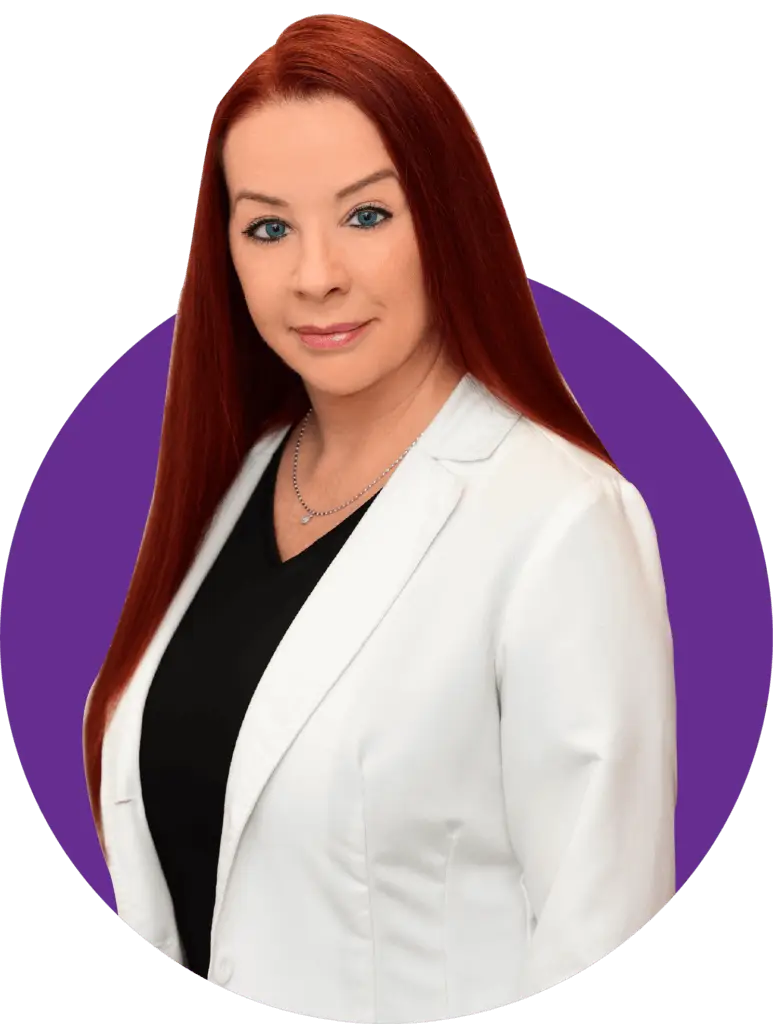 A woman in white jacket standing next to purple circle.