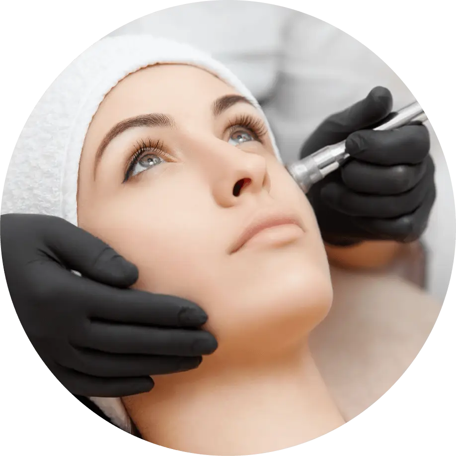 A woman getting her face waxed by an esthetician.